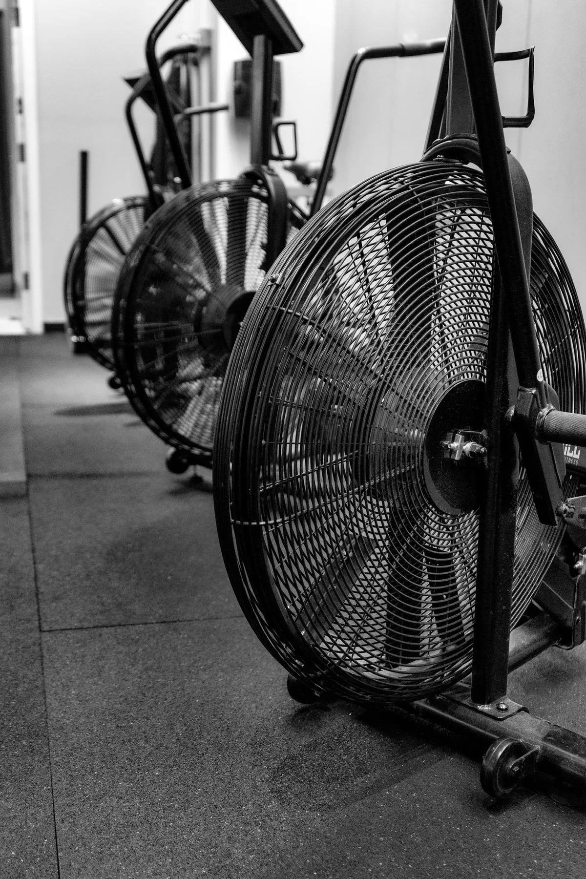A row of air bikes on the training floor at Kutthaus Fitness