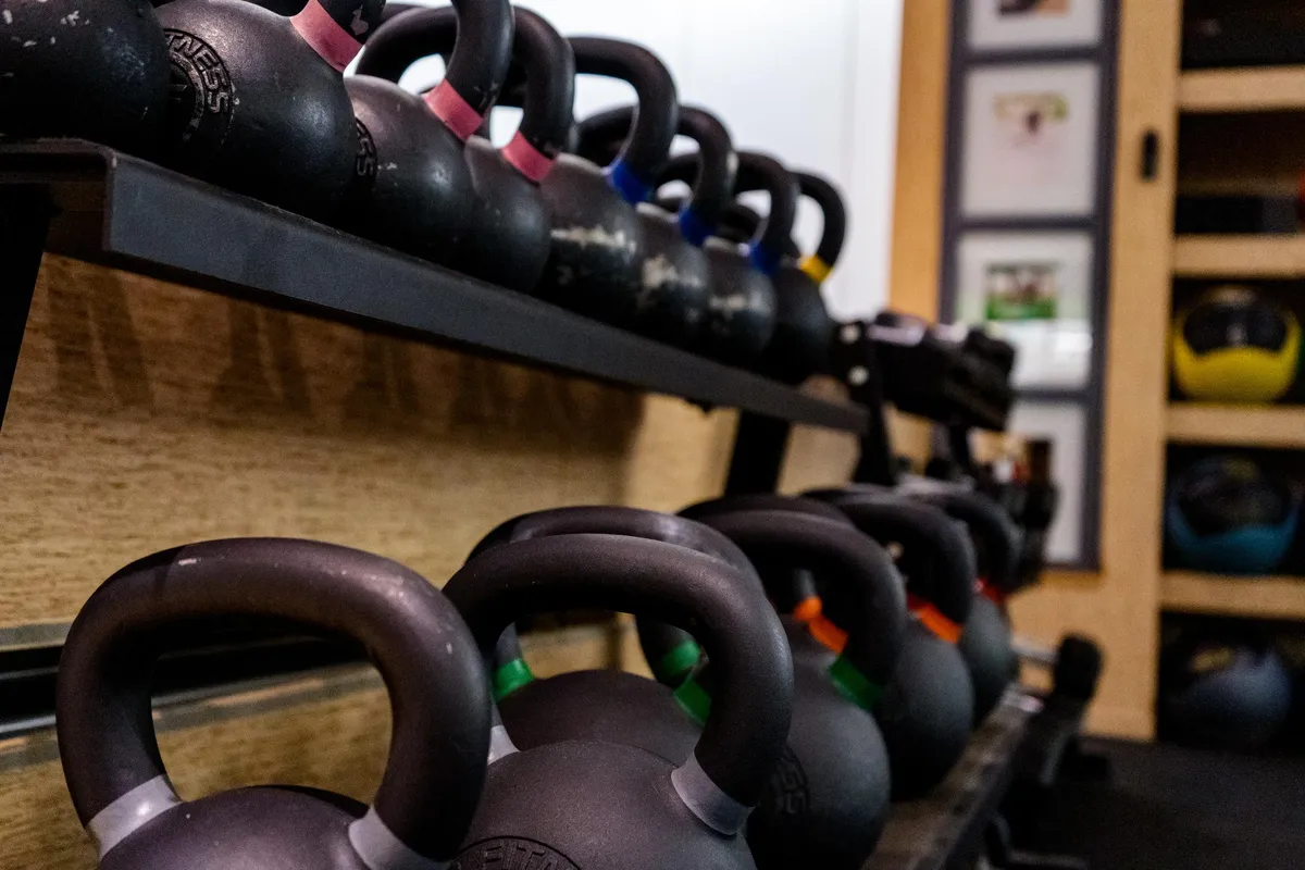 Rows of kettlebells racked and ready at Kutthaus Fitness